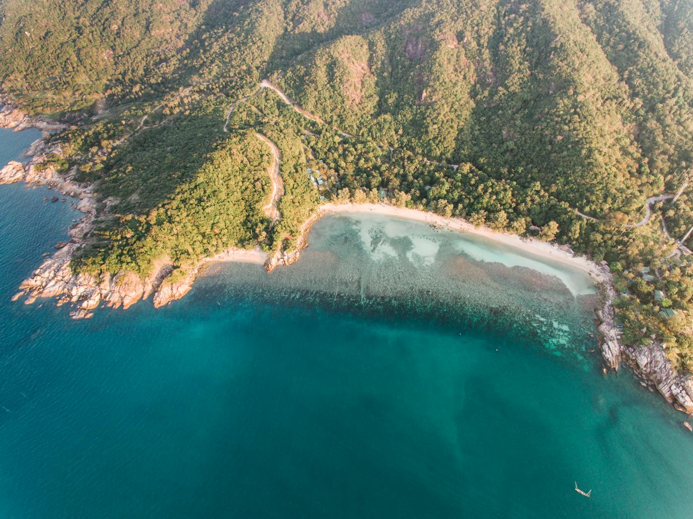 Golden-hour aerial of a Koh Phangan cove